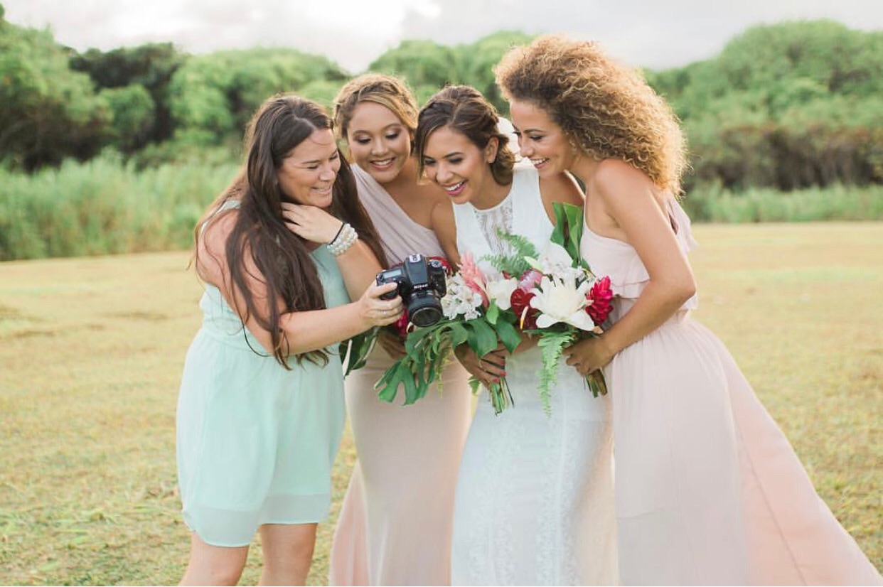 How to Market Yourself Offline - Showit Wedding Photographer showing images to bridesmaids