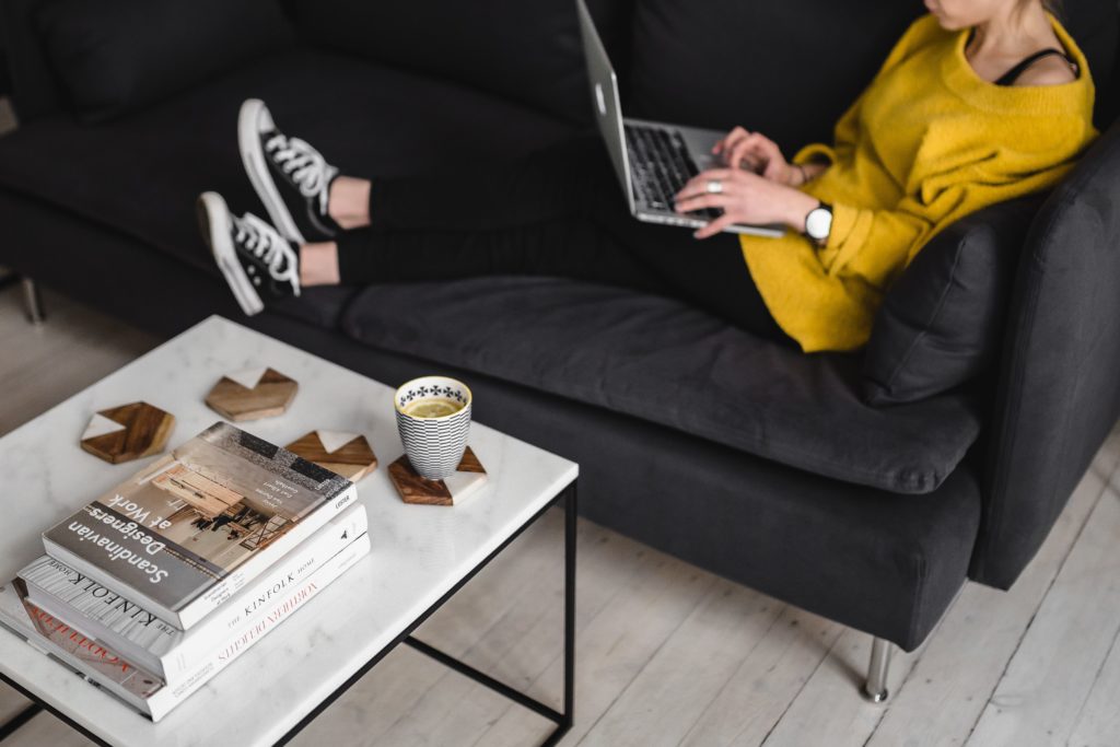 kaboompics_Young-woman-sitting-on-the-sofa-and-working-on-her-laptop - Showit Tips for Refreshing Your Website this Off-Season to make it a highly converting machine for your business